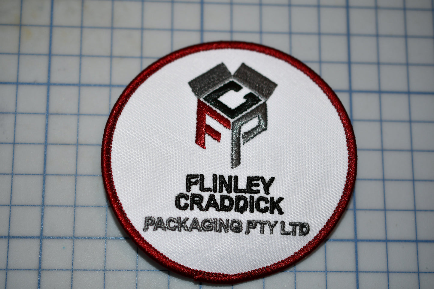 a patch with a logo for a packaging company
