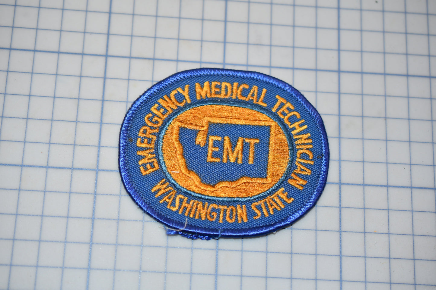 a patch with the text "EMT Washington State" and a map of the state of Washington.