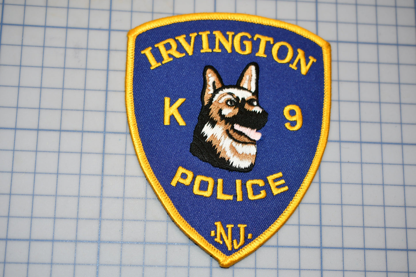 a k9 police badge on a cutting board