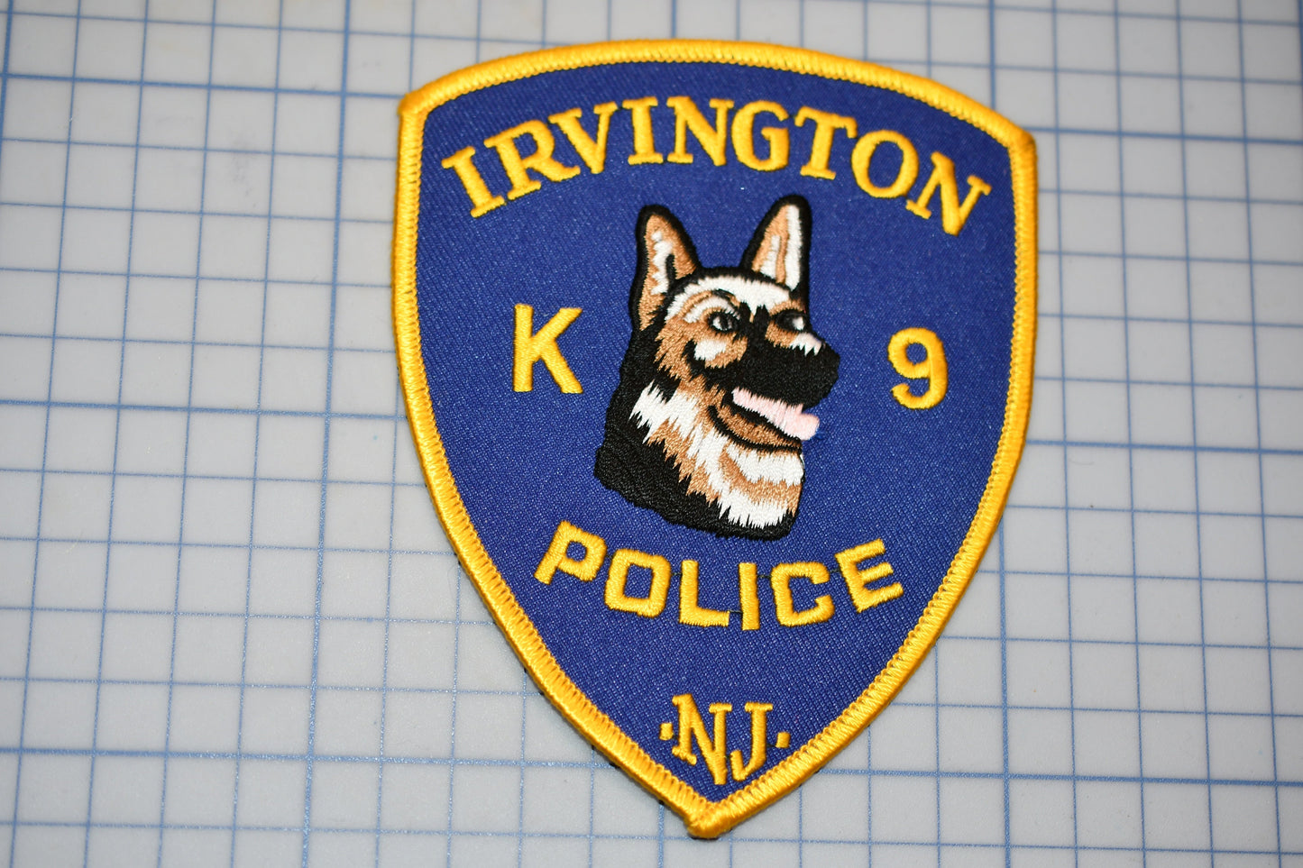 a k9 police badge on a cutting board