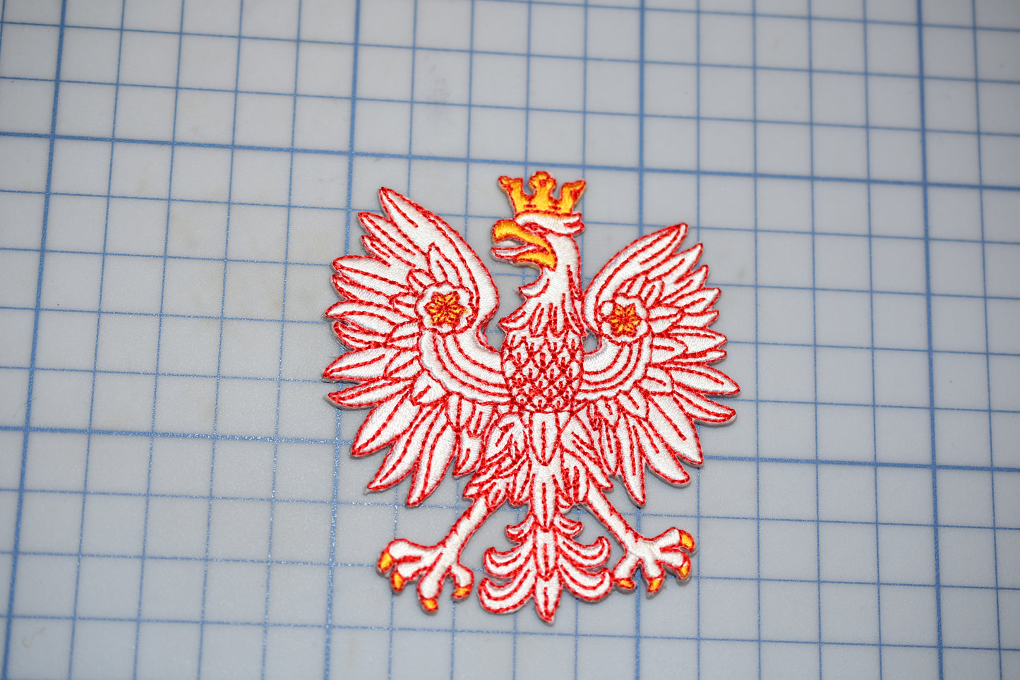 a red and white bird with a crown on it