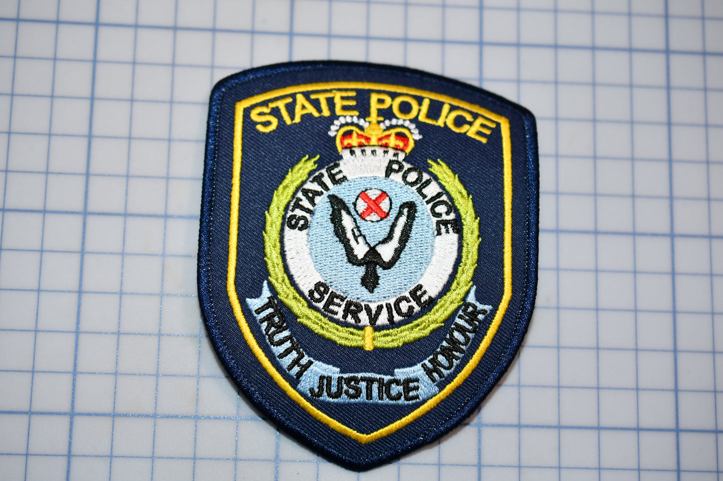 a state police badge on a piece of paper