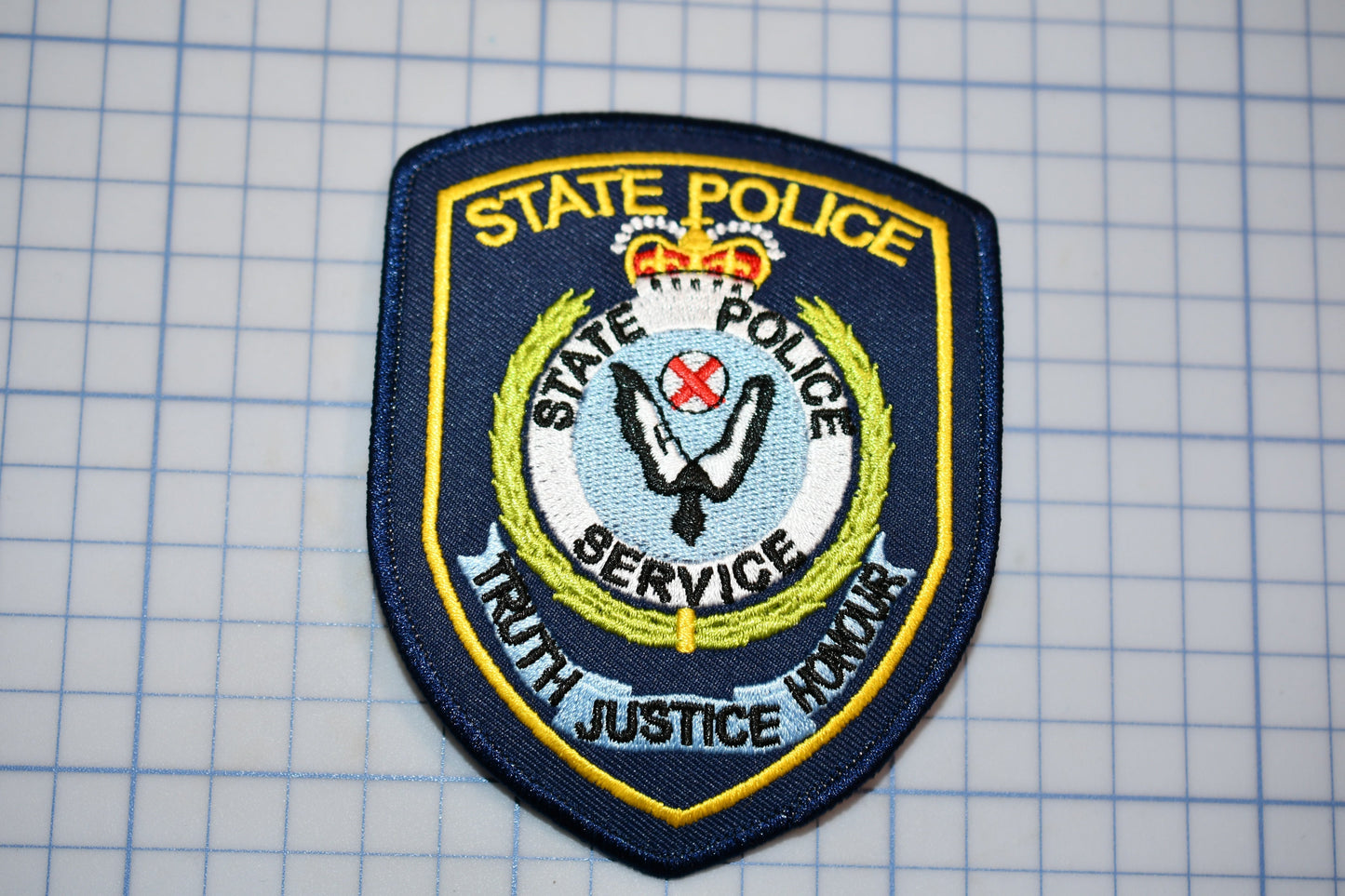 a state police badge on a piece of paper