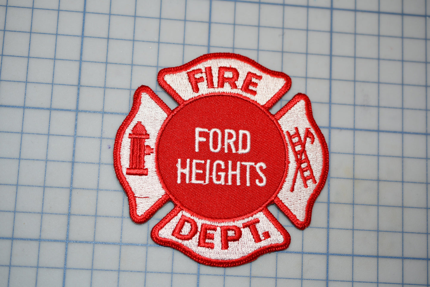 a red and white fire department patch with the text "FIRE" and "DEPT."