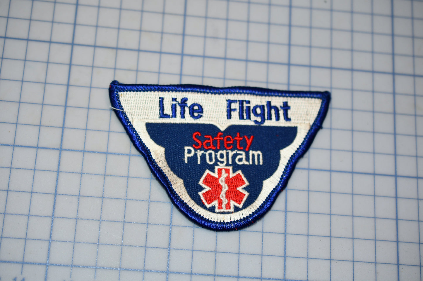 a patch with the text "Life Flight Safety Program" and a medical symbol, indicating it is a safety program related to aviation.