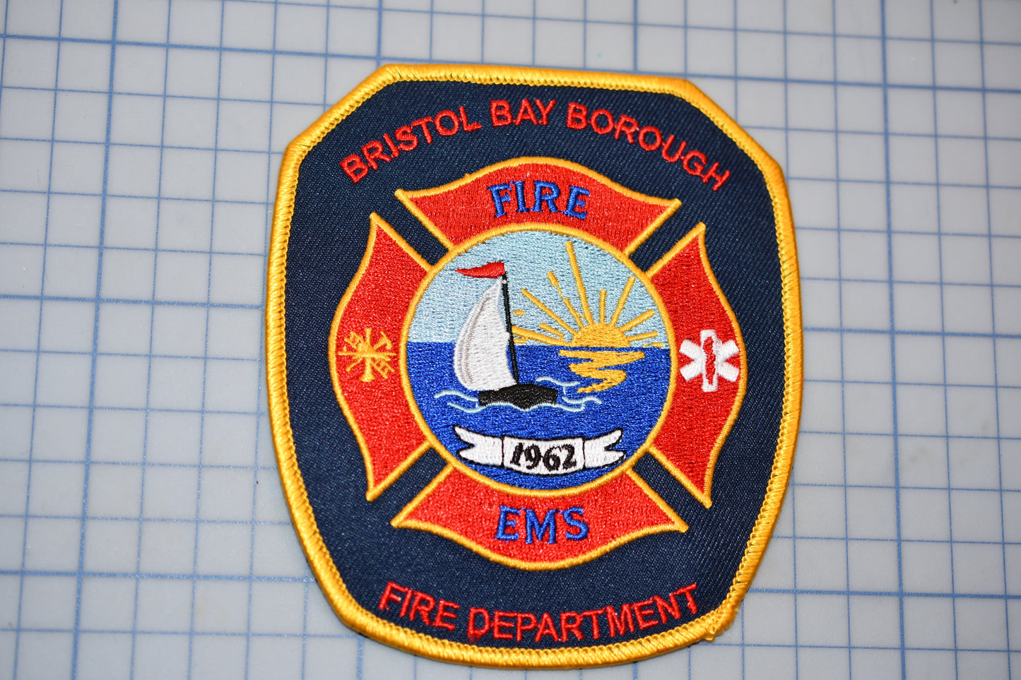 a fire department patch with a boat on it