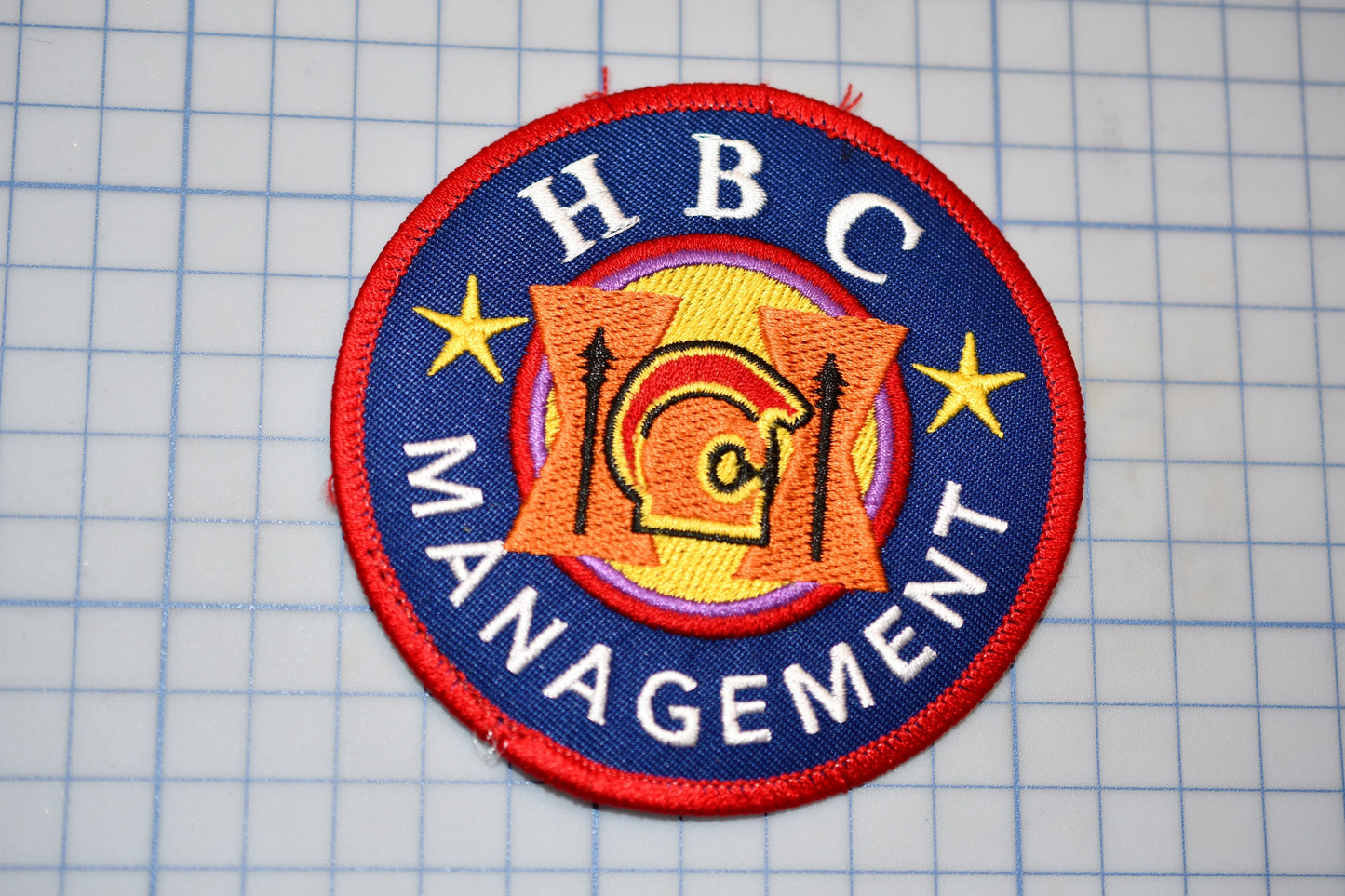 a patch with the words hbc management on it