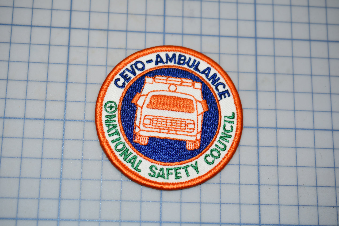 a patch with the text "CEVO-AMBULANCE" and "NATIONAL SAFETY COUNCIL" printed on it, along with an image of an ambulance.