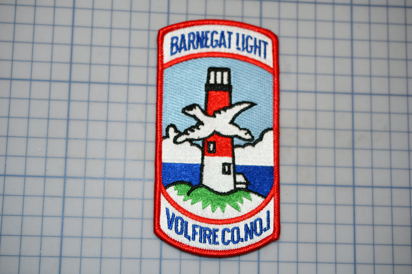 a patch with a picture of a lighthouse on it