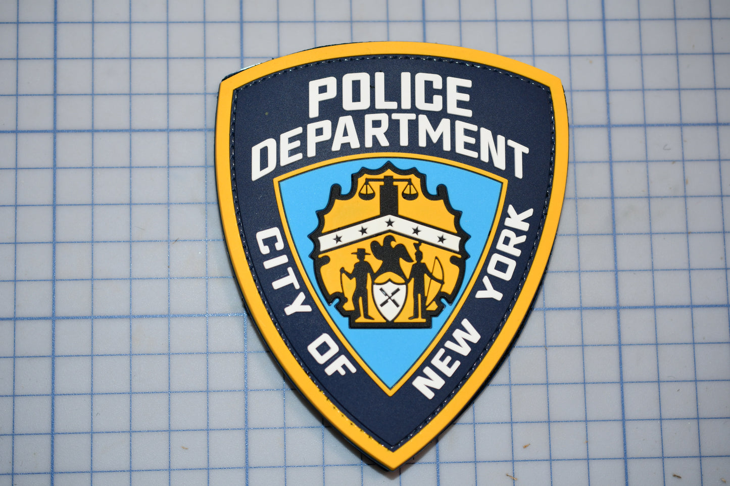 a police badge on a blue and yellow background