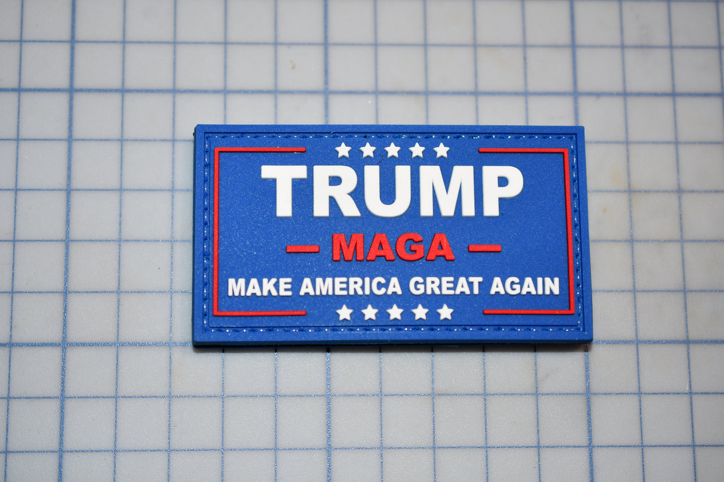 a trump campaign patch on a tile floor