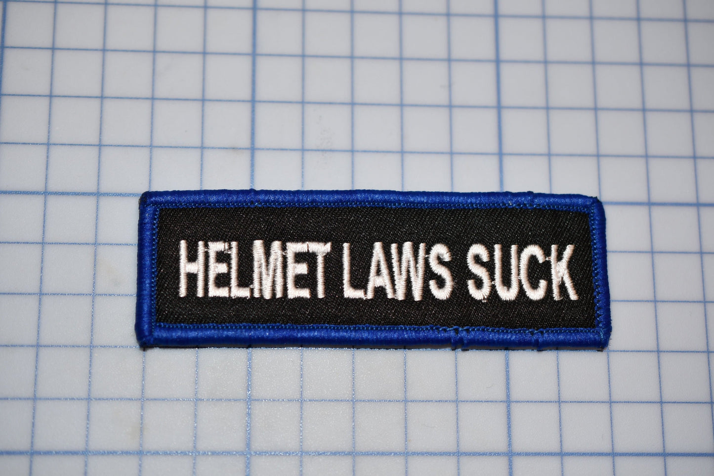 A "Helmet Laws Suck" Sew On Biker Patch (B30-366)