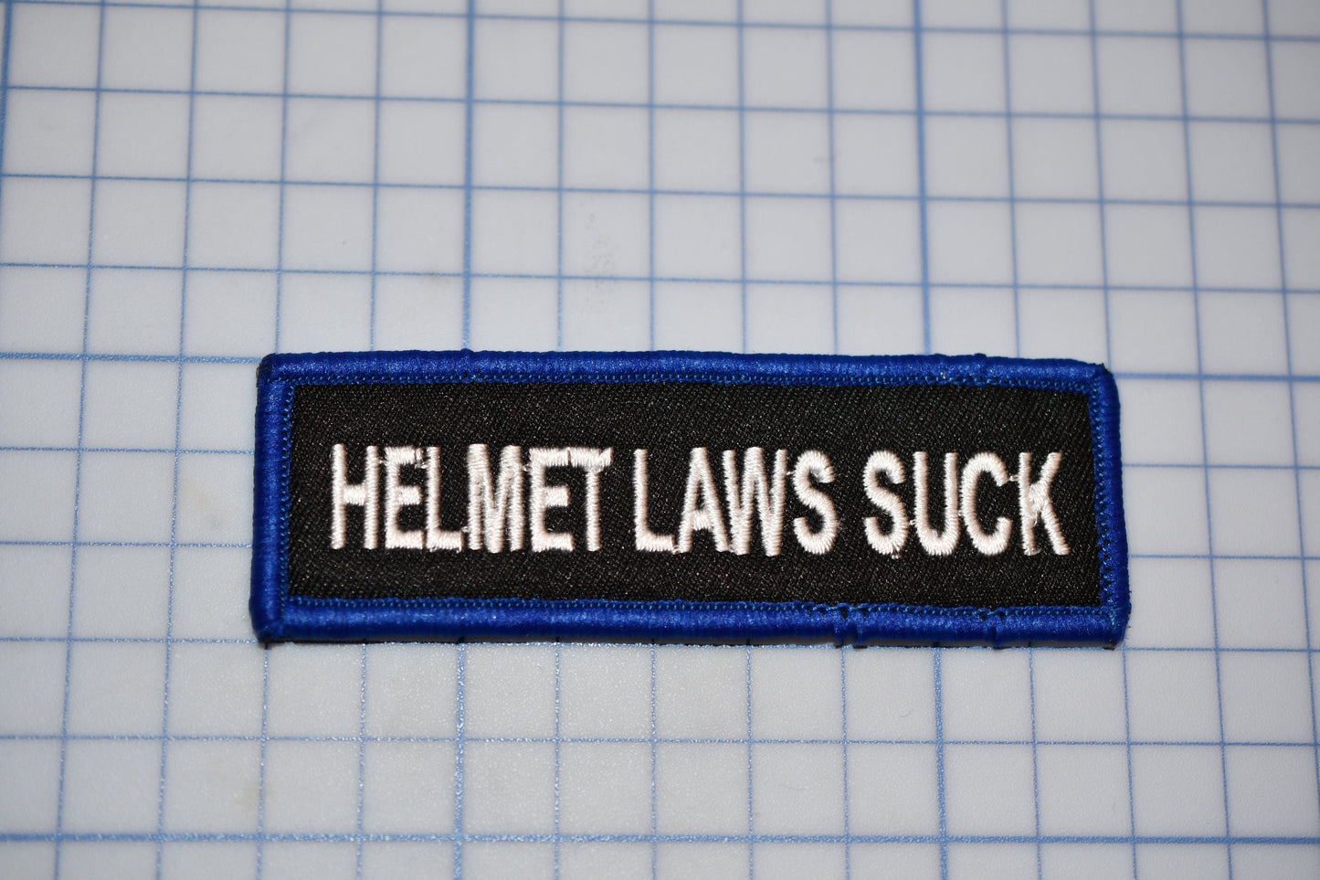 A "Helmet Laws Suck" Sew On Biker Patch (B30-366)