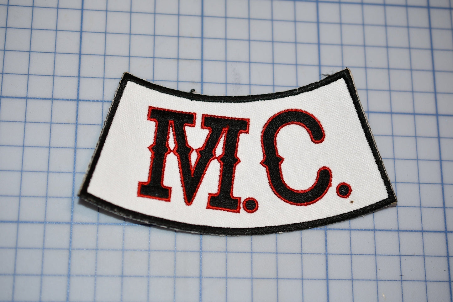 a close up of a patch on a cutting mat