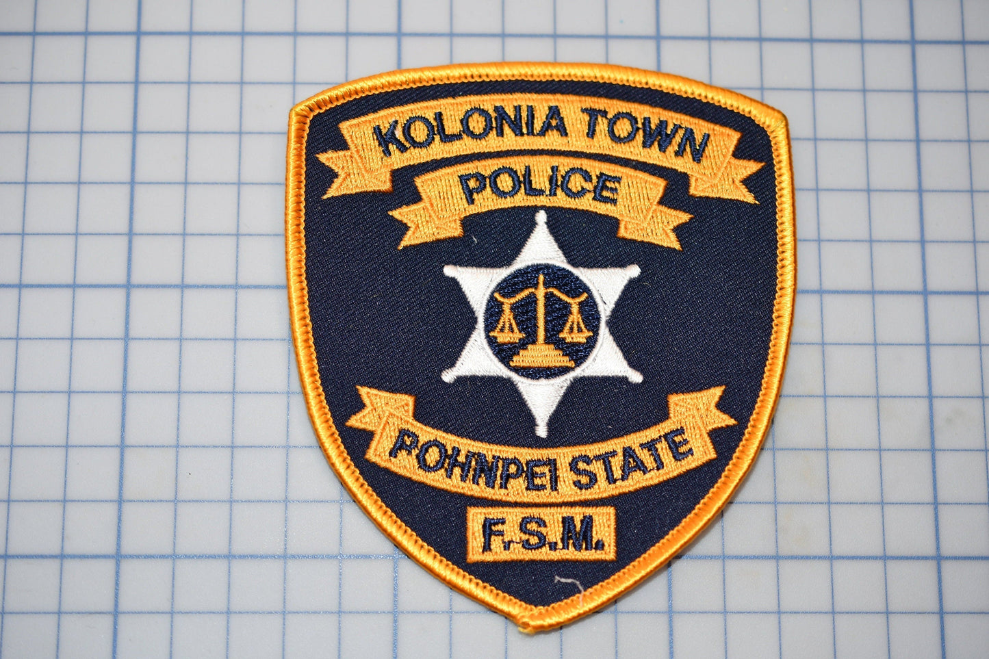 a police patch on a cutting board