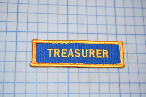 a blue and yellow patch with the word treasures on it