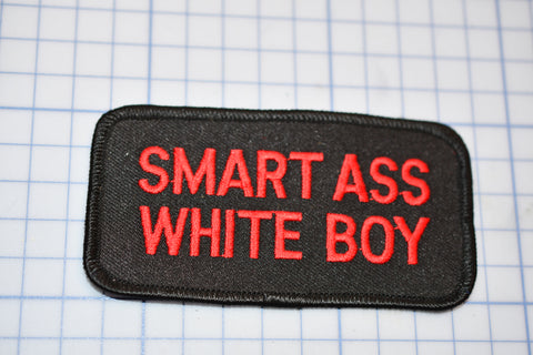 a black and red patch that says smart ass white boy