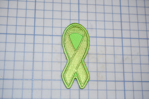 a green ribbon on a cutting board