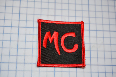 a red and black patch with the letter c on it