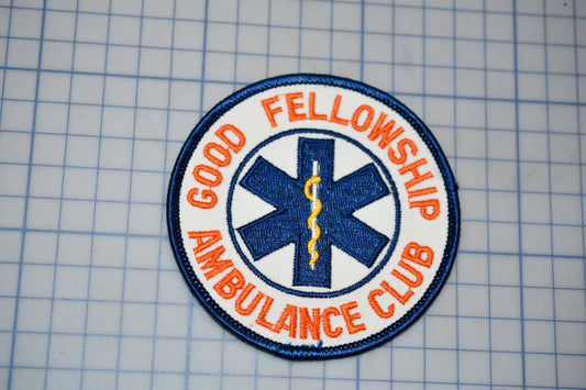 a patch with the text "Good Fellowship Ambulance Club" and a medical symbol, likely representing a medical or emergency services organization.