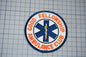 a patch with the text "Good Fellowship Ambulance Club" and a medical symbol, likely representing a medical or emergency services organization.