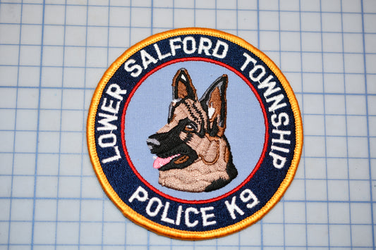 a circular patch with a dog's head in the center, surrounded by the text "Lower Salford Township Police K9".