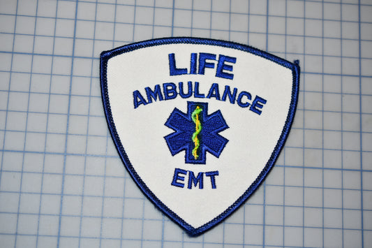 a life-saving ambulance EMT patch with the text "LIFE AMBULANCE EMT" prominently displayed.