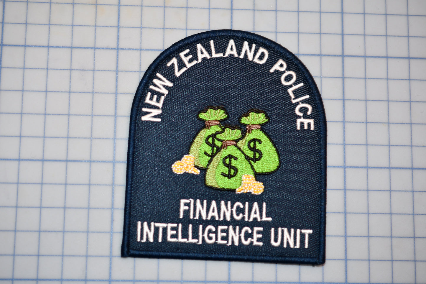 a New Zealand Police Financial Intelligence Unit patch.