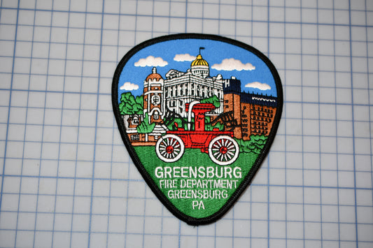 a patch with a picture of a building and a wagon