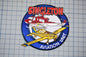 a patch with a red and white helicopter and a yellow airplane, both of which are part of the Singleton Aviation Unit.