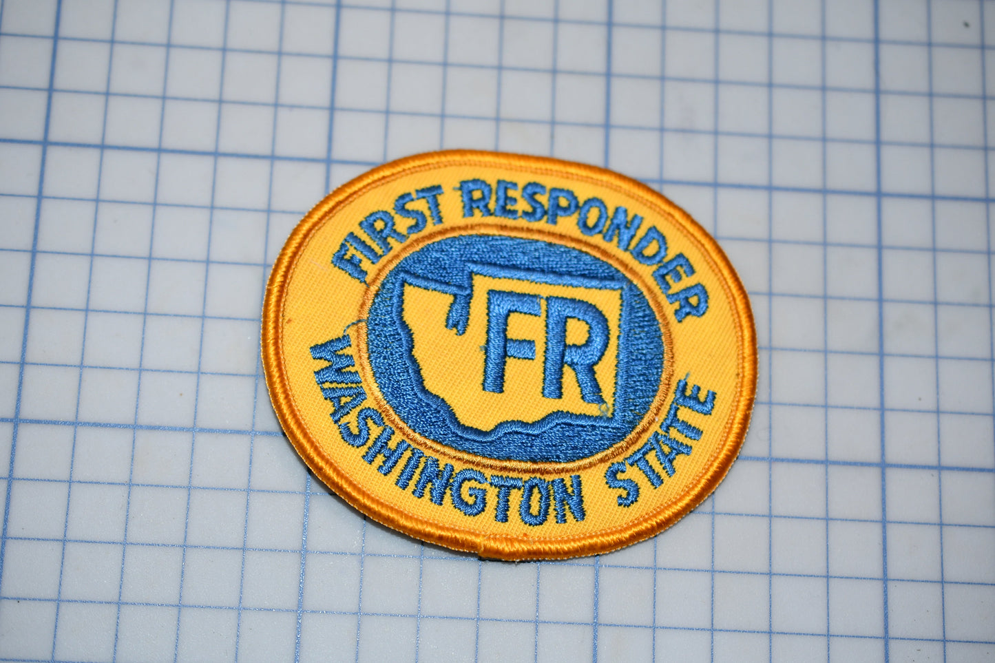 a patch with the text "First Responder Washington State" and a graphic of a state map.