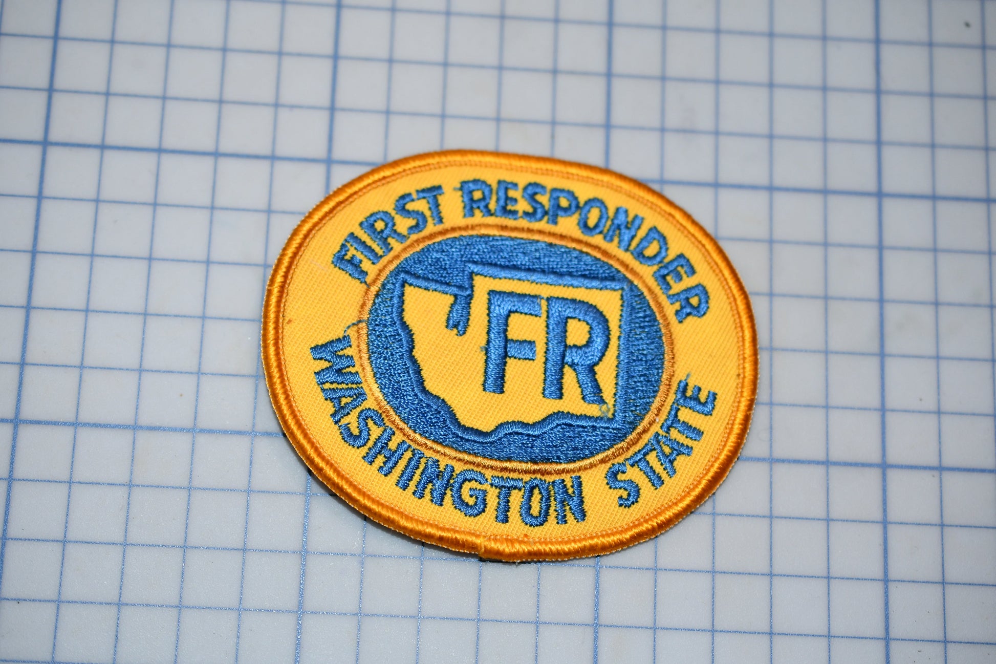a patch with the text "First Responder Washington State" and a graphic of a state map.