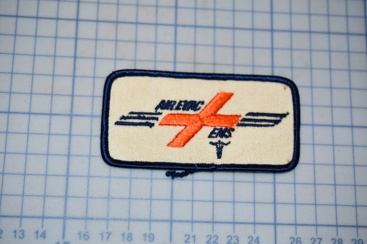 a patch with a logo, located on a grid background.