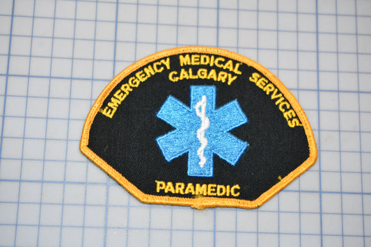 a patch with a blue medical symbol and the words "Emergency Medical Services" written around it.