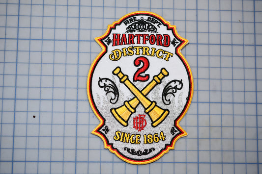 a fire department patch with the text "HARTFORD DISTRICT 2" and "SINCE 1864" on it.