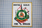 a patch with a fire department emblem, including a fire engine, a fire hose, and a fire helmet, along with the text "Fire Brigade" and "Pipes & Drums".