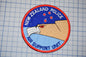 a circular patch with the text "NEW ZEALAND POLICE AIR SUPPORT UNIT" and an illustration of a bird of prey, likely a hawk, with a star on its head.