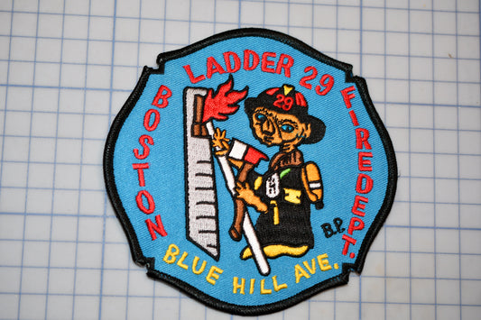 A blue and red patch with a cartoon firefighter character, representing the Boston Fire Department.