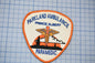 A badge or patch with the text "Parkland Ambulance" and "Prince Albert Paramedic" printed on it, along with an image of a medical symbol.