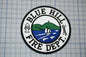 a blue hill fire department patch on a piece of paper