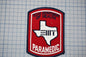A red and blue Texas Department of Health Paramedic patch is displayed against a grid background.
