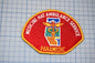 a red and yellow patch with the word "PARAMEDIC" written on it, along with a medical symbol and the word "MEDICINE HAT AMBULANCE SERVICE" written around it.