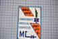 a patch with text and a symbol, including the words "MEDICAL CENTER", "EMERGENCY MEDICAL SERVICES", and "JERSEY CITY N.J."