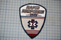 a patch with the text "RAPID RESPONSE EMS" and a medical symbol, likely representing a medical emergency response team or organization.