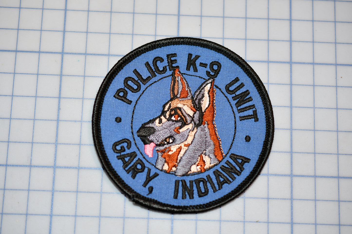 A police K-9 unit patch with the name Gary, Indiana, and the text "POLICE K-9 UNIT" printed on it.