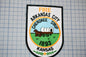 a patch with a picture of a horse drawn wagon