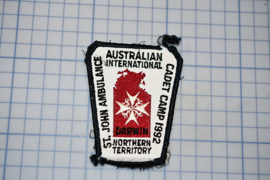 a patch with text and a red star, placed on a grid background.