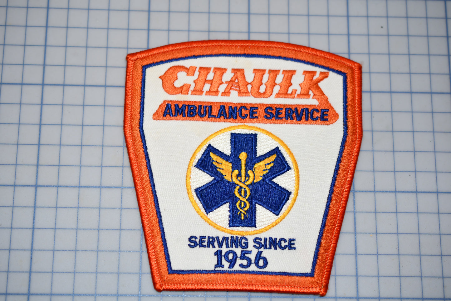 a patch with the text "CHAUK AMBULANCE SERVICE" and a medical symbol, indicating that it is a patch representing the Chauk Ambulance Service.
