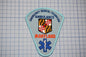 a patch with the text "EMERGENCY MEDICAL TECHNICIAN AMBULANCE" and "MARYLAND" printed on it, along with a shield-shaped emblem and a blue medical cross symbol.