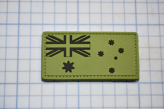 a green patch with a picture of a flag on it